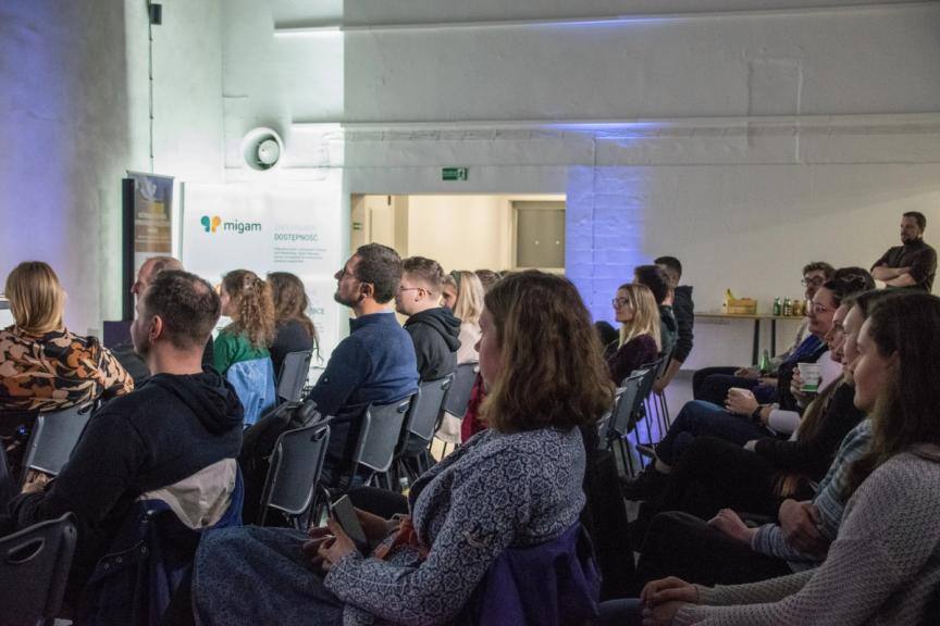 Audience during the meetup - 4 rows of people sitting and listening the speech