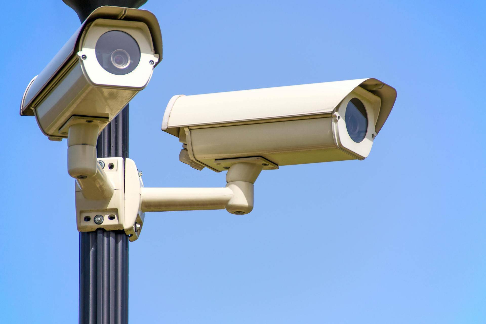 two security cameras against a blue background